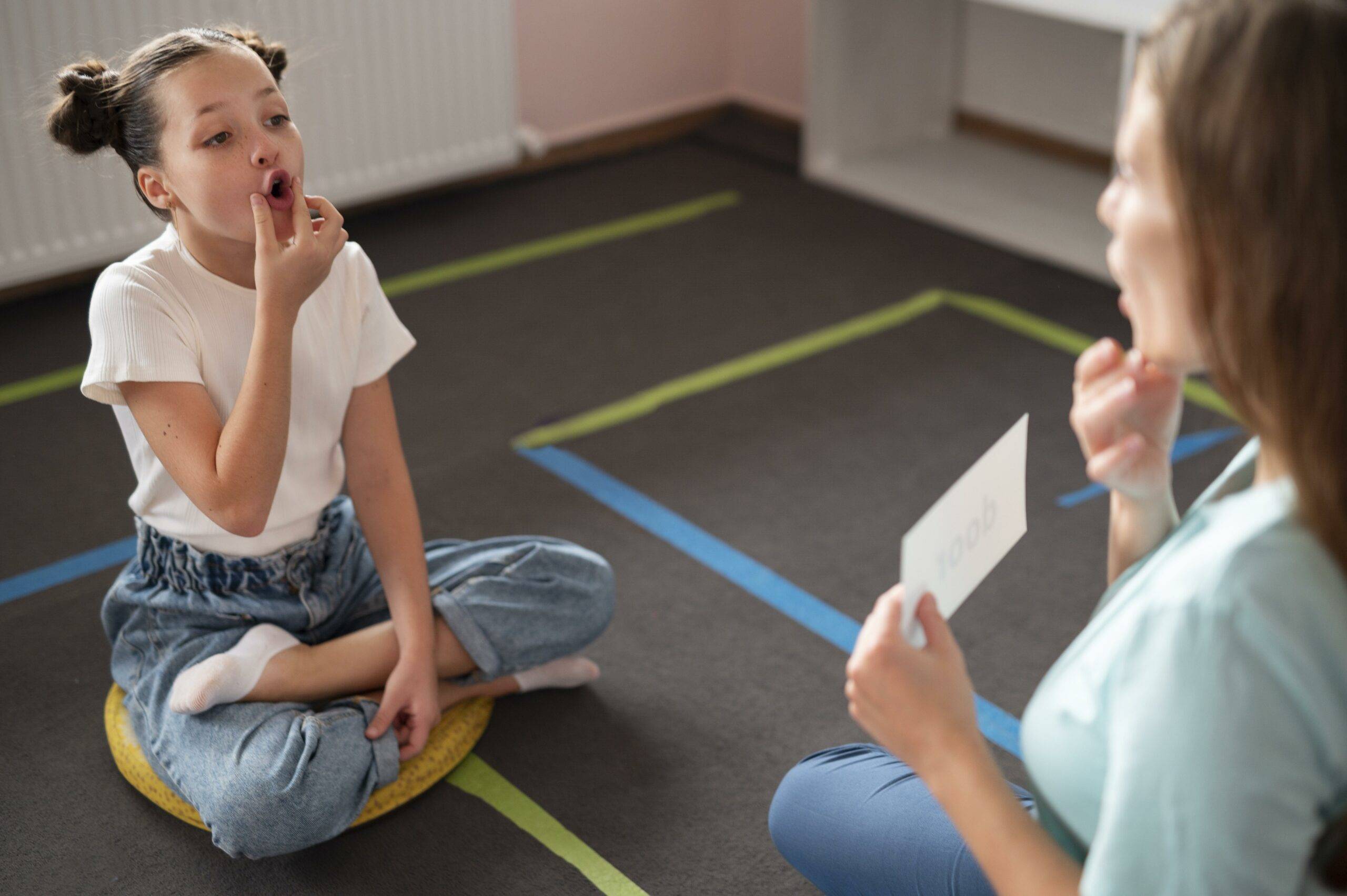 psychologist-helping-little-girl-speech-therapy-indoors